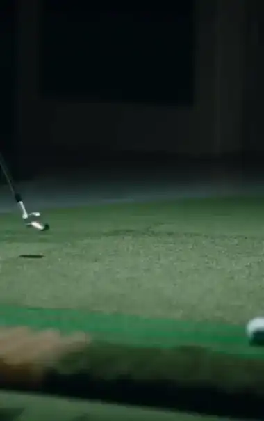 A player’s feet on the hitting plate with the sensor line lit beneath them.